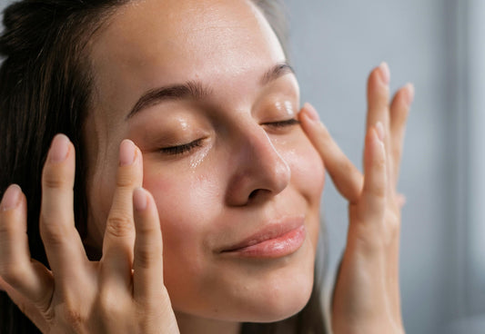 Woman applying skin care on her face